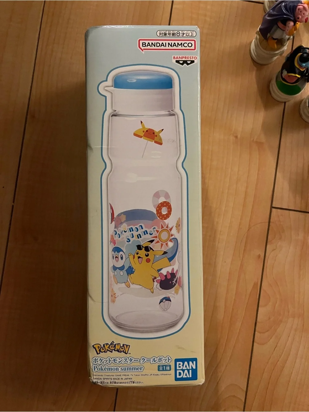 Pokemon Charmander Clear Water Bottle with Blue Cap and Rainbow Beach Art